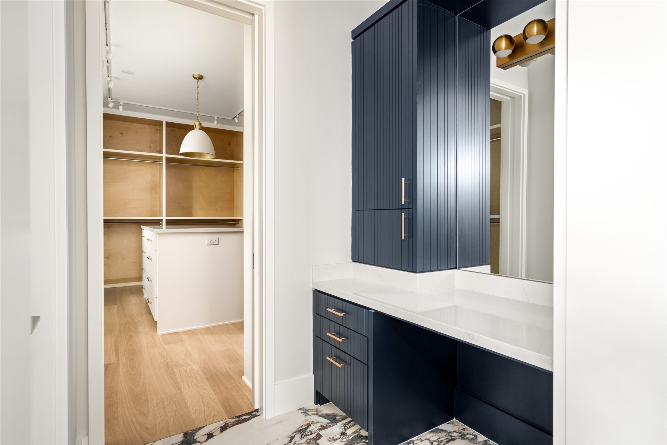 4006 Overbrook Lane Houston, TX 77027 - Photo 31 of 50 A built-in vanity offers a seamless transition into the expansive primary closet beyond.