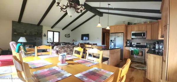 a living room with lots of furniture and a chandelier