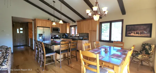 a view of a dining room with furniture and chandelier