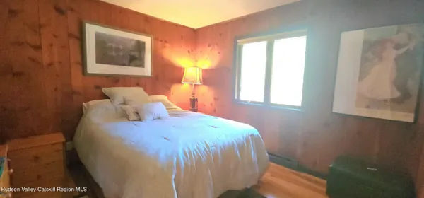 a bed sitting in a bedroom next to a window