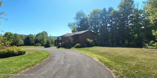 a view of a road with a house in the background