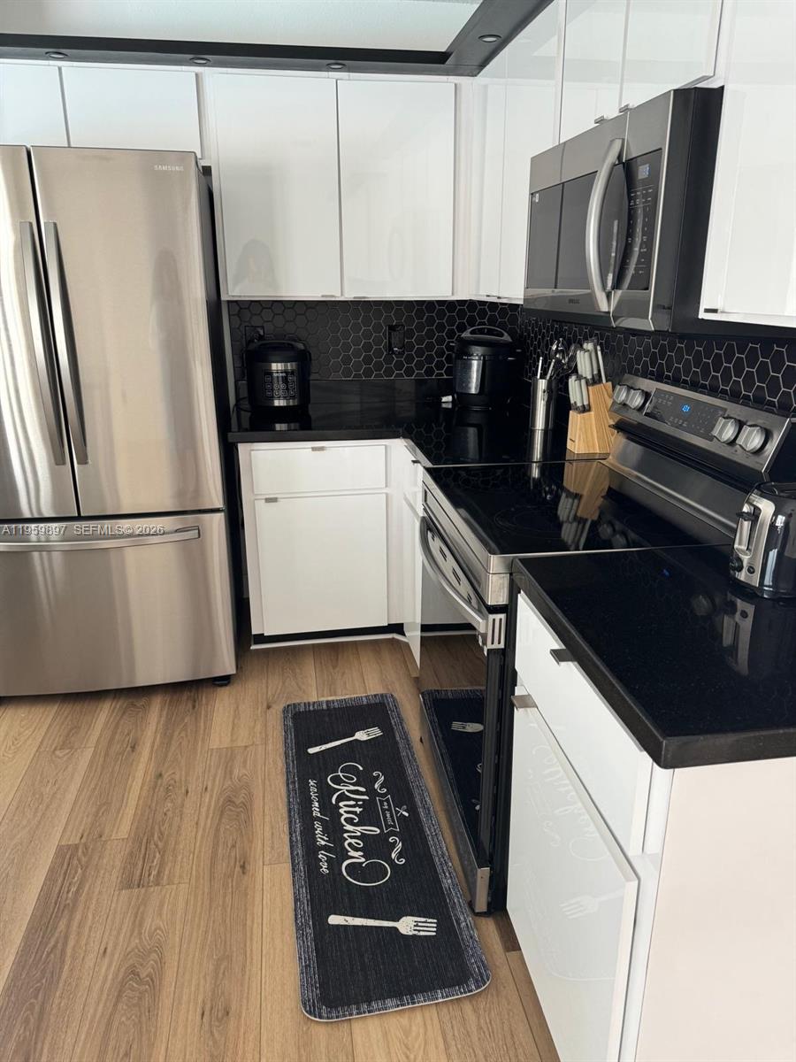 2359 Kings Crest Road Kissimmee, FL 34744 - Photo 5 of 18 a kitchen with a refrigerator and a stove
