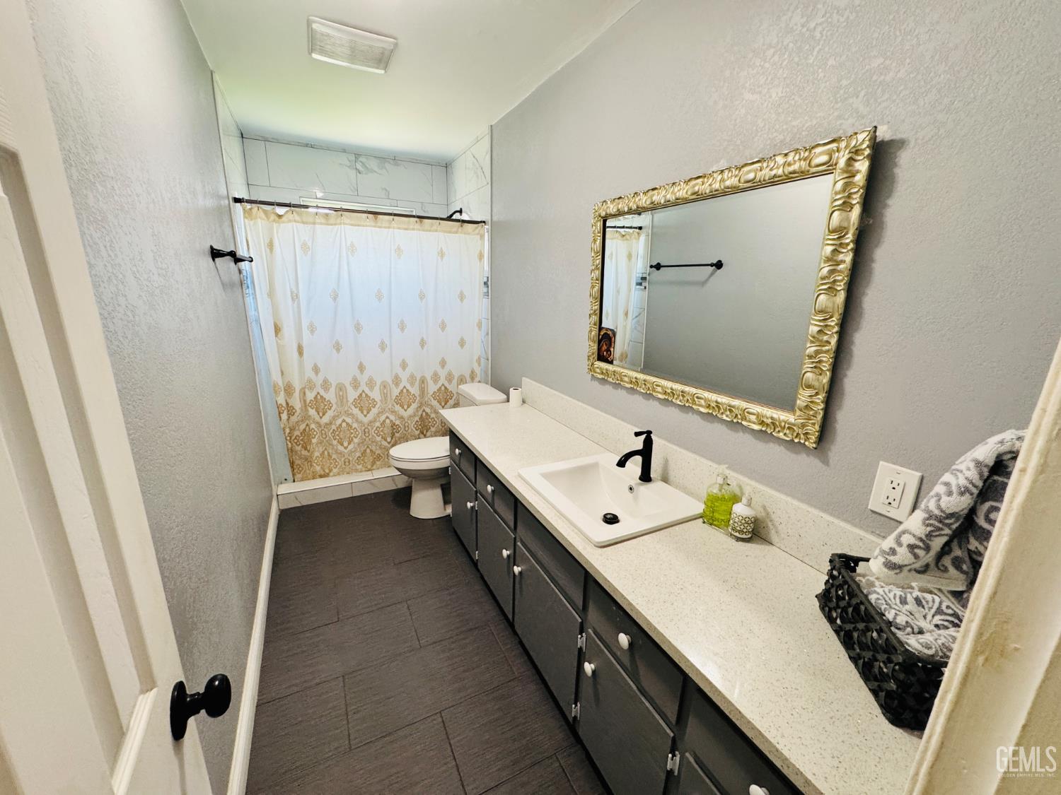 Undisclosed Address Delano, CA 93215 - Photo 4 of 14 a bathroom with a double vanity sink toilet and mirror