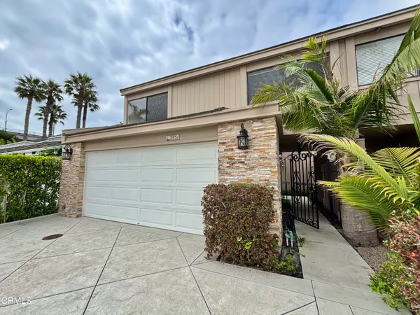 a living room with furniture wooden floor and a large window