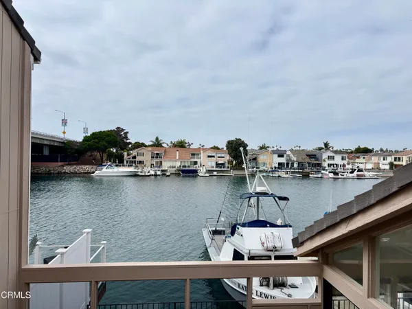a bathroom with a granite countertop sink a toilet a mirror and shower