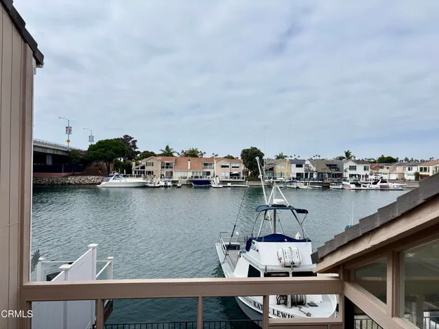 a bathroom with a granite countertop sink a toilet a mirror and shower