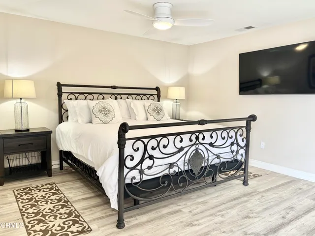 a bed room with a bed and a chair