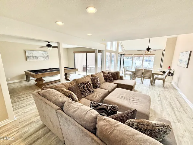 a kitchen with stainless steel appliances granite countertop a sink a stove and a wooden floors