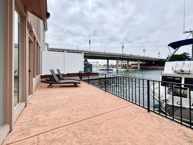 a dining room with furniture and a floor to ceiling window