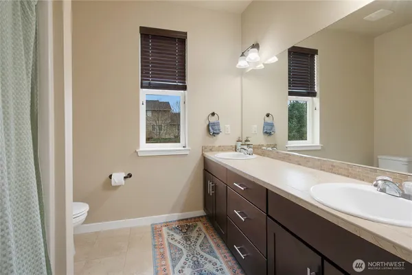 a bathroom with a double vanity sink and a mirror