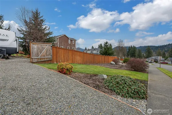 a view of a backyard with plants and a garden