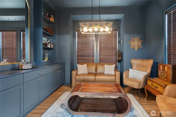 a living room with furniture and a chandelier