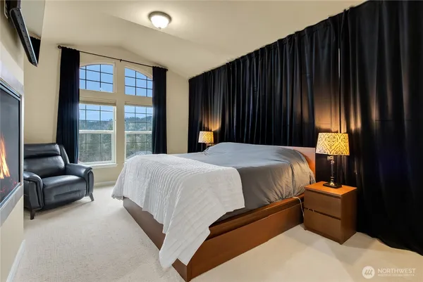 a bedroom with a bed and a couch