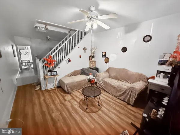 a living room with furniture and stairs