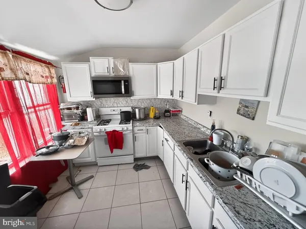 a kitchen with a stove a sink and a refrigerator