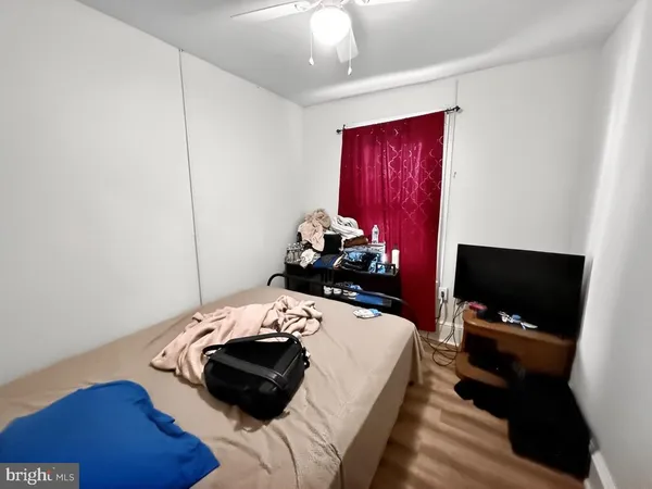 a bedroom with a bed and a tv