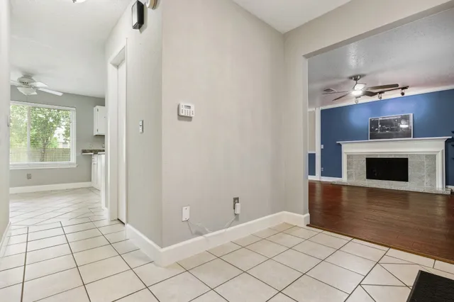 a room with a fireplace and a view of wooden floor