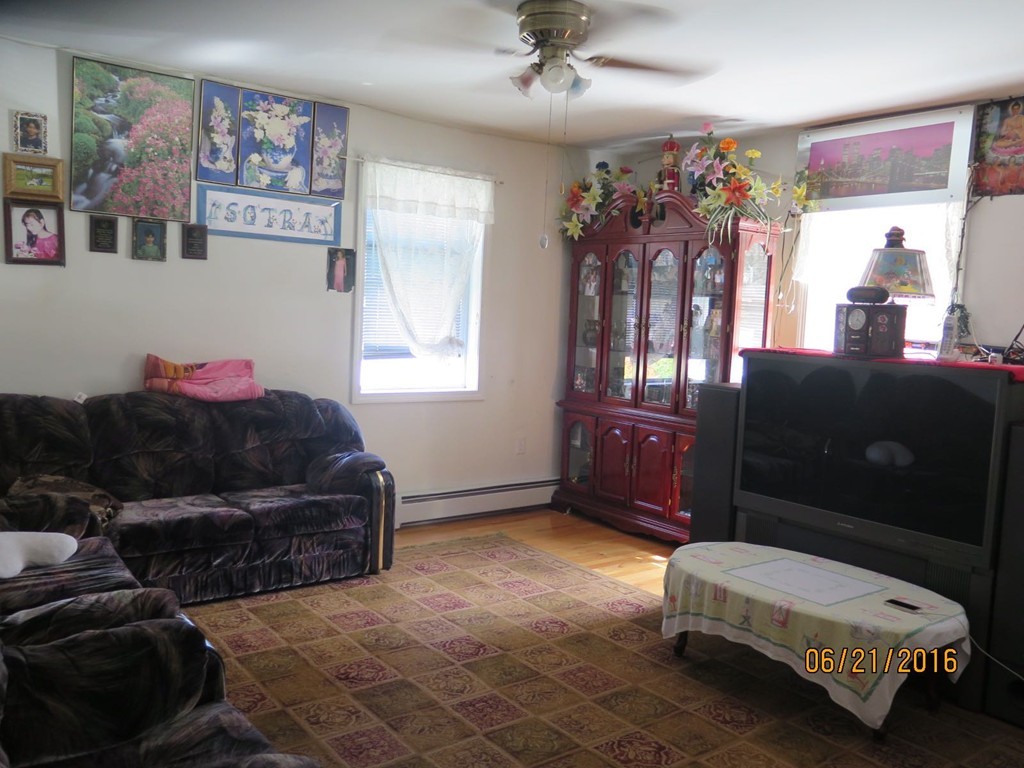 11-13 Gardner Street Worcester, MA 01610 - Photo 11 of 20 a living room with furniture stairs and a window
