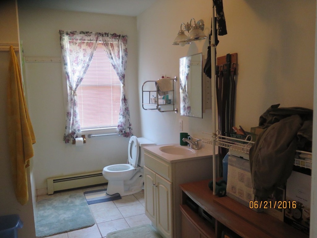 11-13 Gardner Street Worcester, MA 01610 - Photo 12 of 20 a bathroom with a sink toilet and mirror