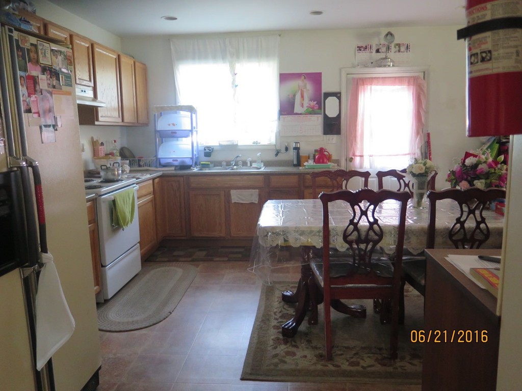 11-13 Gardner Street Worcester, MA 01610 - Photo 13 of 20 a kitchen with stainless steel appliances granite countertop a refrigerator and a stove