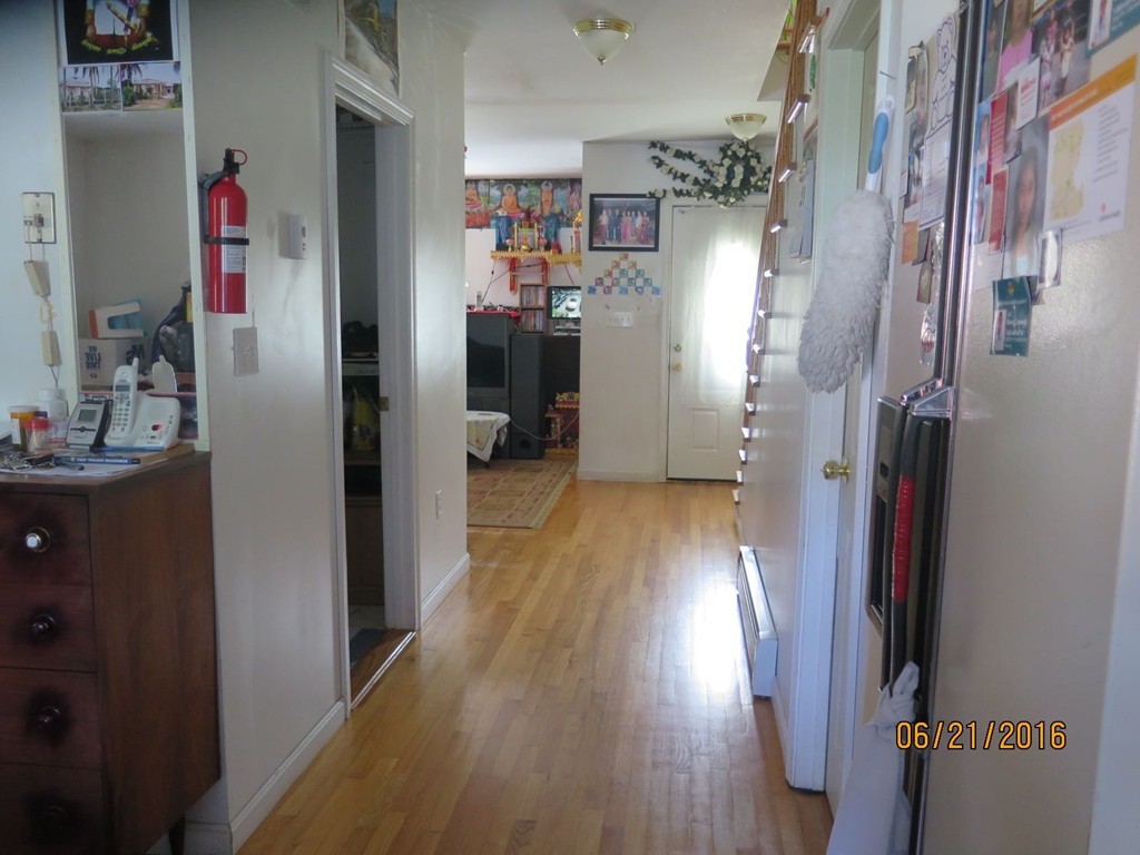 11-13 Gardner Street Worcester, MA 01610 - Photo 15 of 20 a view of a hallway with wooden floor and closet
