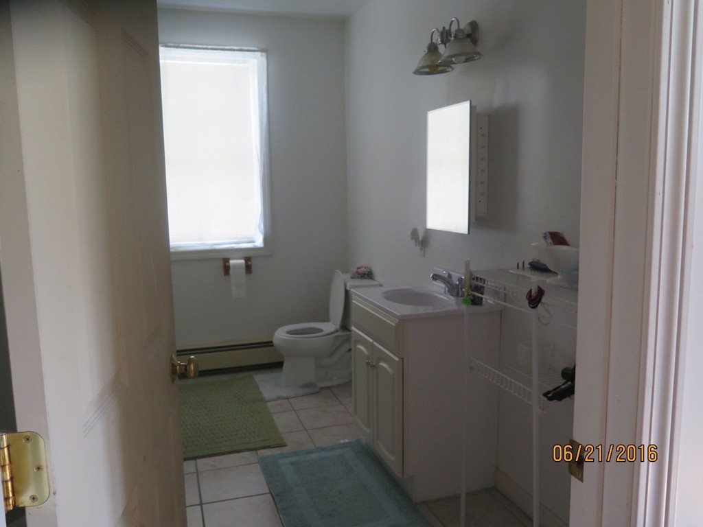 11-13 Gardner Street Worcester, MA 01610 - Photo 19 of 20 a bathroom with a sink toilet and mirror