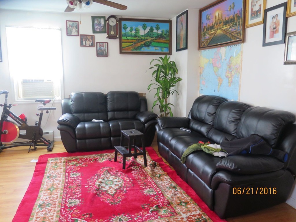 11-13 Gardner Street Worcester, MA 01610 - Photo 2 of 20 a living room with furniture and a rug