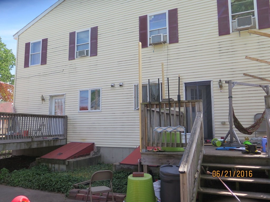 11-13 Gardner Street Worcester, MA 01610 - Photo 4 of 20 a view of a house with a yard and furniture