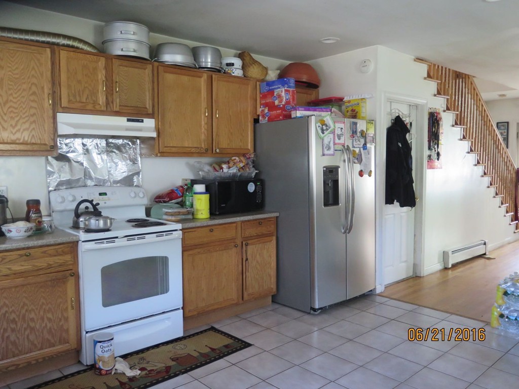 11-13 Gardner Street Worcester, MA 01610 - Photo 6 of 20 a kitchen with stainless steel appliances granite countertop a refrigerator and a sink