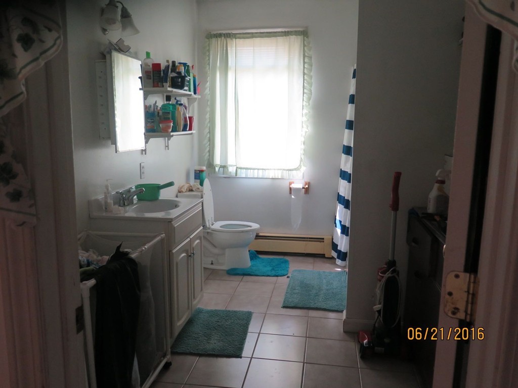 11-13 Gardner Street Worcester, MA 01610 - Photo 8 of 20 a bathroom with a sink a toilet and tub