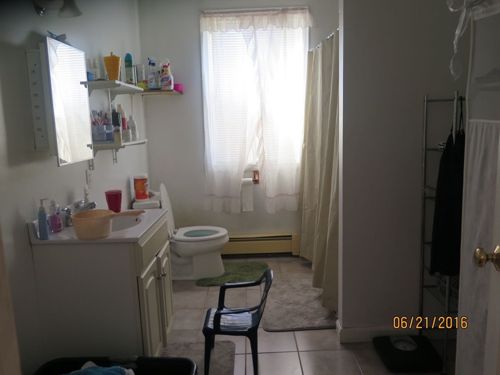 11-13 Gardner Street Worcester, MA 01610 - Photo 9 of 20 a bathroom with a sink toilet and a mirror