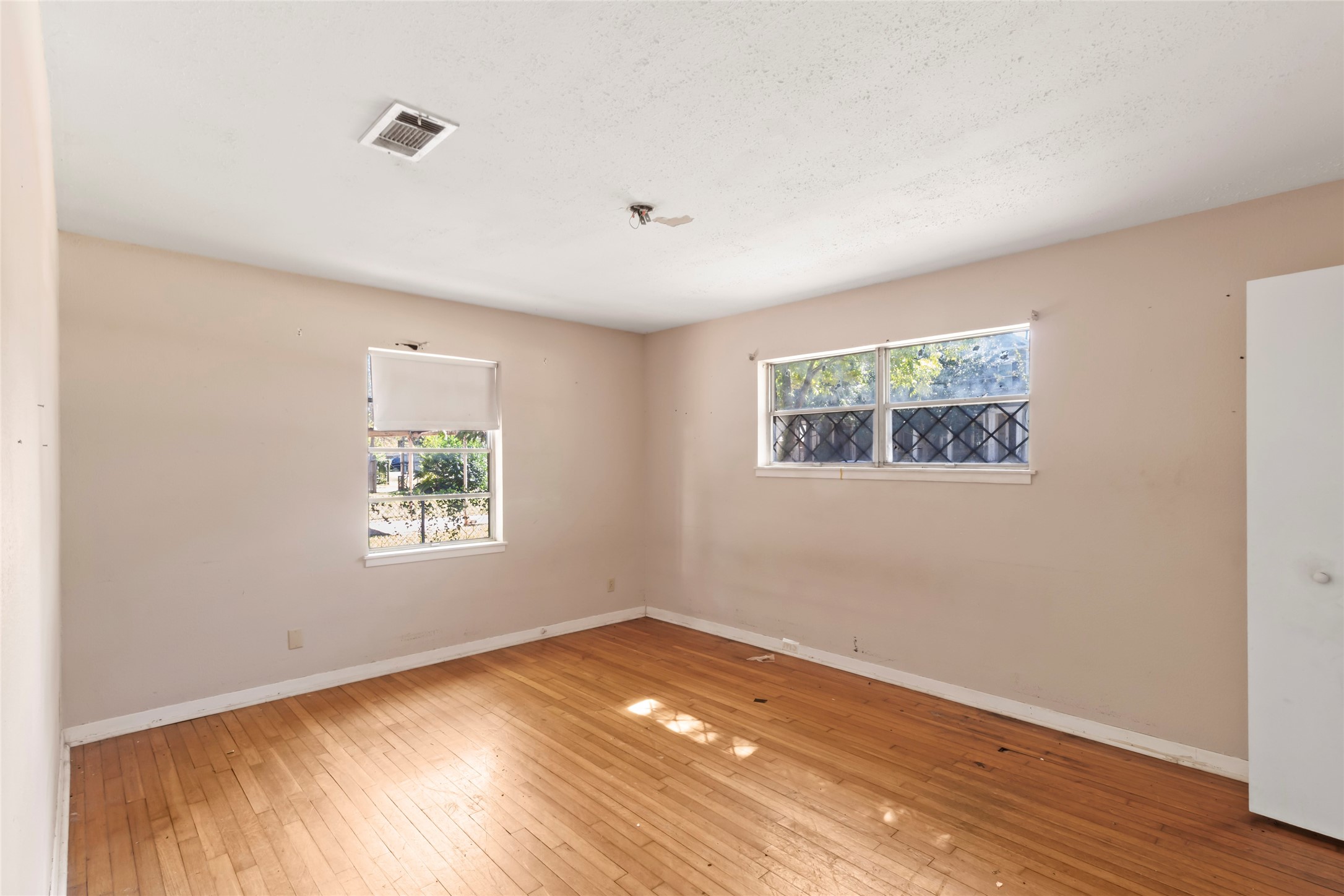 1427 West 22nd Street Houston, TX 77008 - Photo 11 of 23 a view of empty room with wooden floor and fan