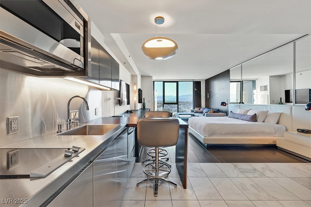 4381 West Flamingo Road, Unit 1609 Las Vegas, NV 89103 - Photo 2 of 27 Bedroom with floor to ceiling windows and a sink