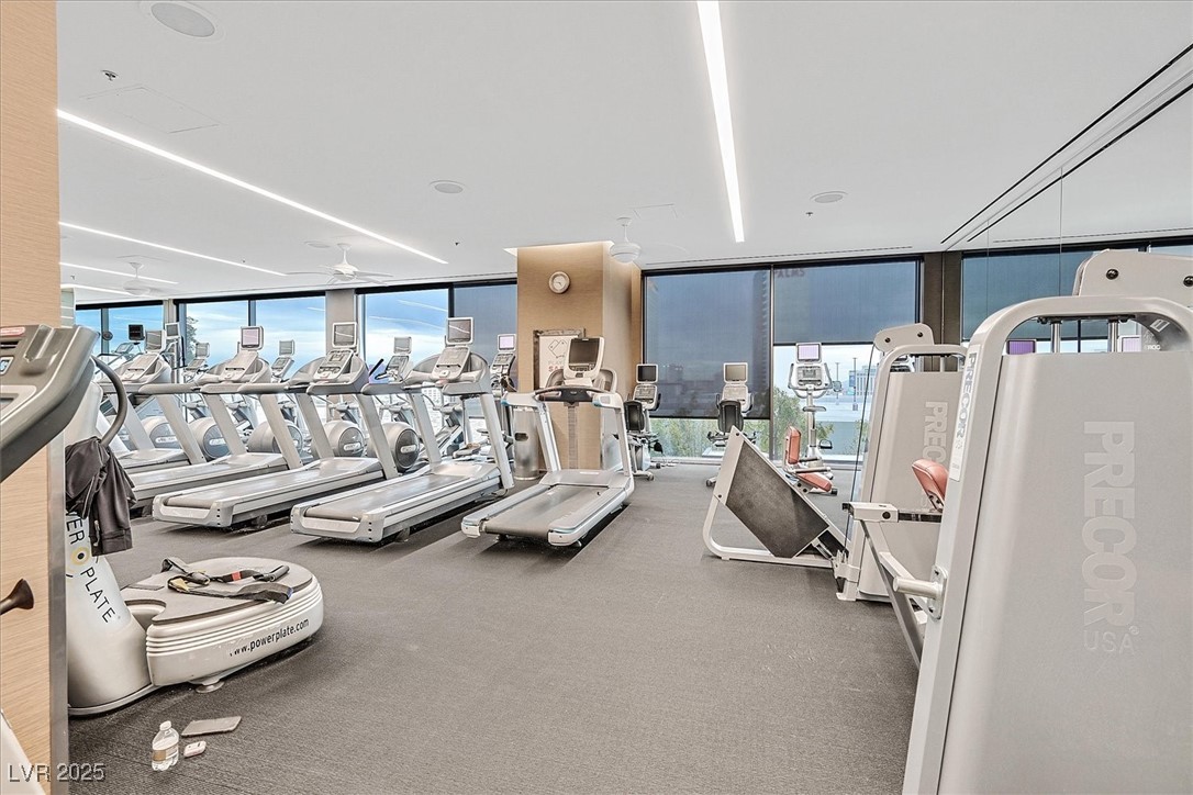4381 West Flamingo Road, Unit 1609 Las Vegas, NV 89103 - Photo 23 of 27 Workout area featuring expansive windows and ceiling fan