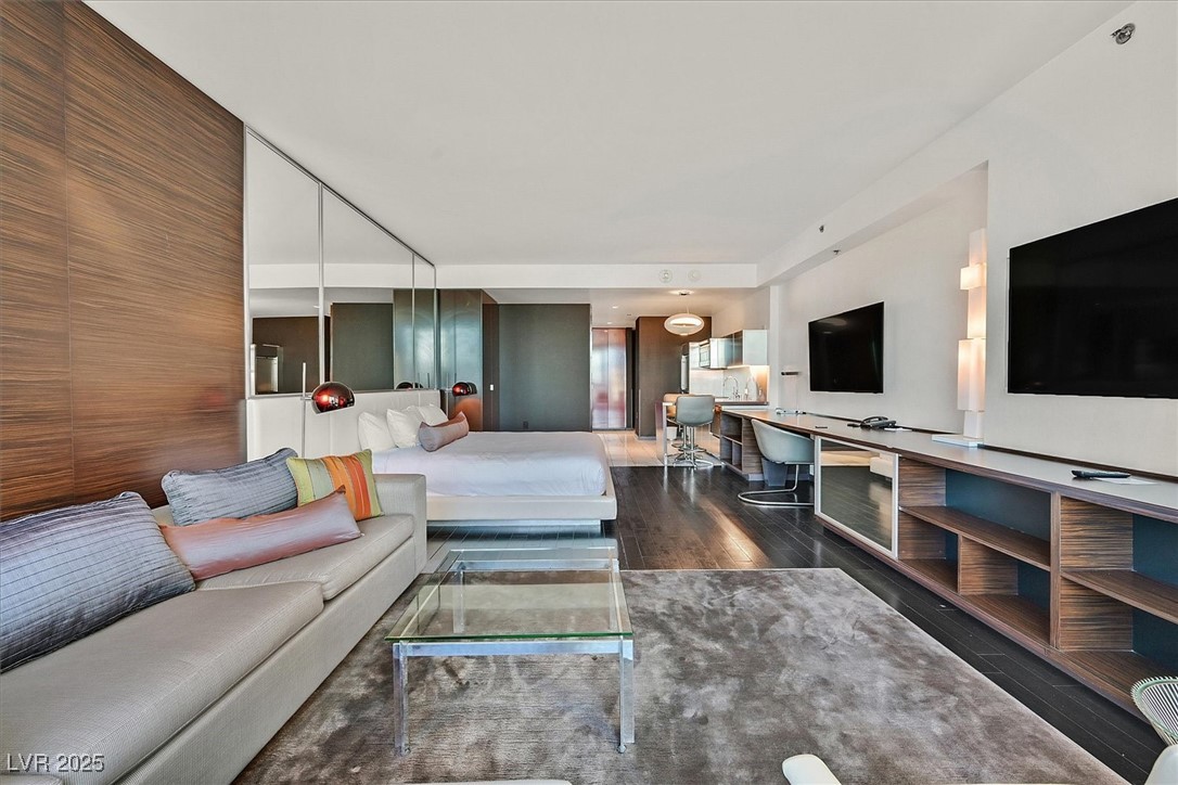 4381 West Flamingo Road, Unit 1609 Las Vegas, NV 89103 - Photo 9 of 27 Living area featuring dark wood-style floors