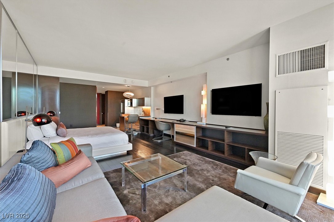 4381 West Flamingo Road, Unit 1609 Las Vegas, NV 89103 - Photo 10 of 27 Living area featuring visible vents and wood finished floors