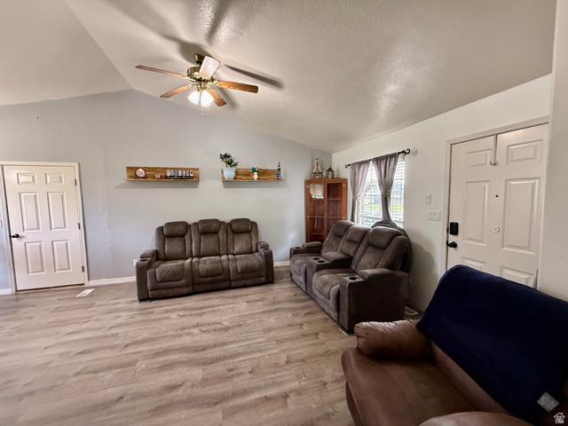 1353 360 West Payson, UT 84651 - Photo 5 of 16 Spacious interior featuring a vaulted ceiling with a ceiling fan, light wood-finish flooring, and light-toned wall paint