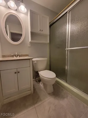 a bathroom with a toilet a sink and a mirror