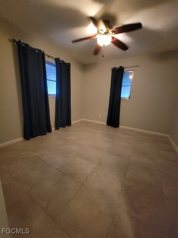 341 Richland Road Lehigh Acres, FL 33936 - Photo 14 of 16 a view of a livingroom with a ceiling fan and window