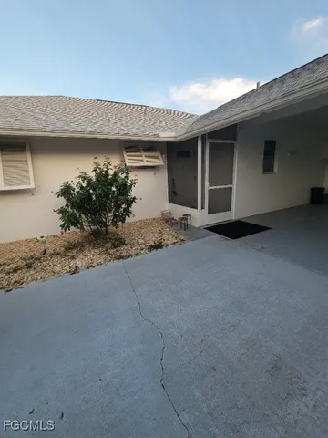 a view of a house with potted plants