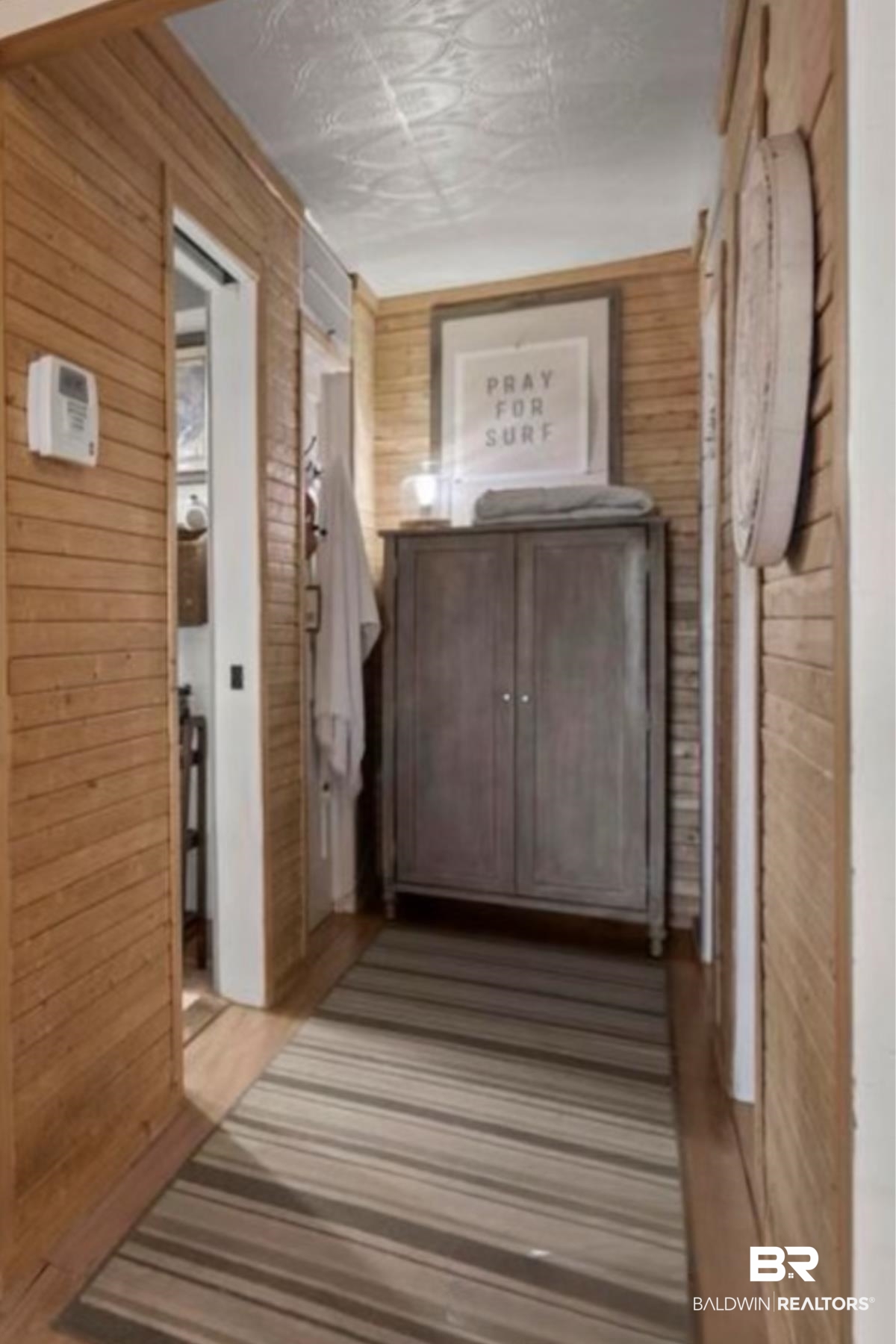 2514 Muscogee Road Gulf Shores, AL 36542 - Photo 17 of 60 Hallway with light hardwood / wood-style floors and wooden walls