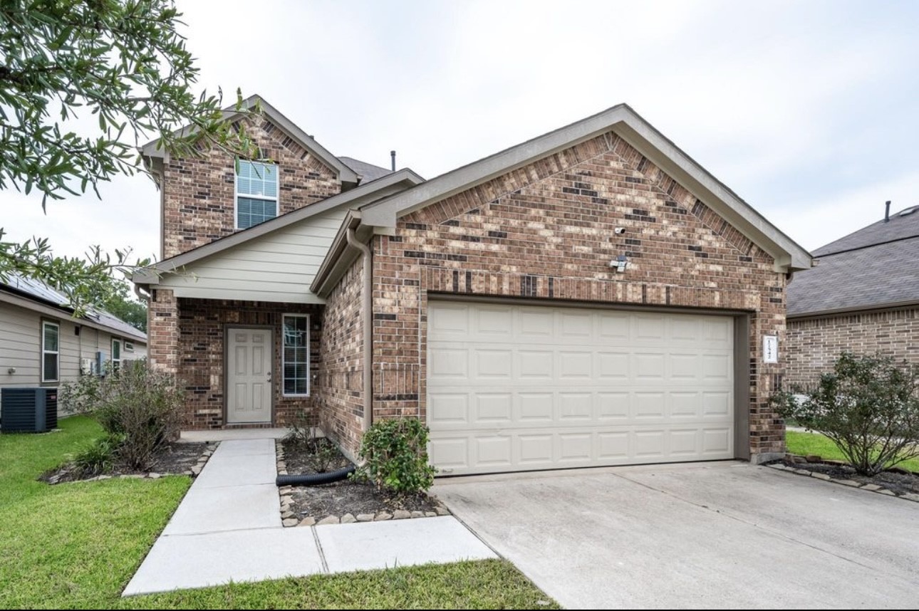 17542 Holroyd Road Humble, TX 77346 - Photo 2 of 16 a front view of house with garage and yard
