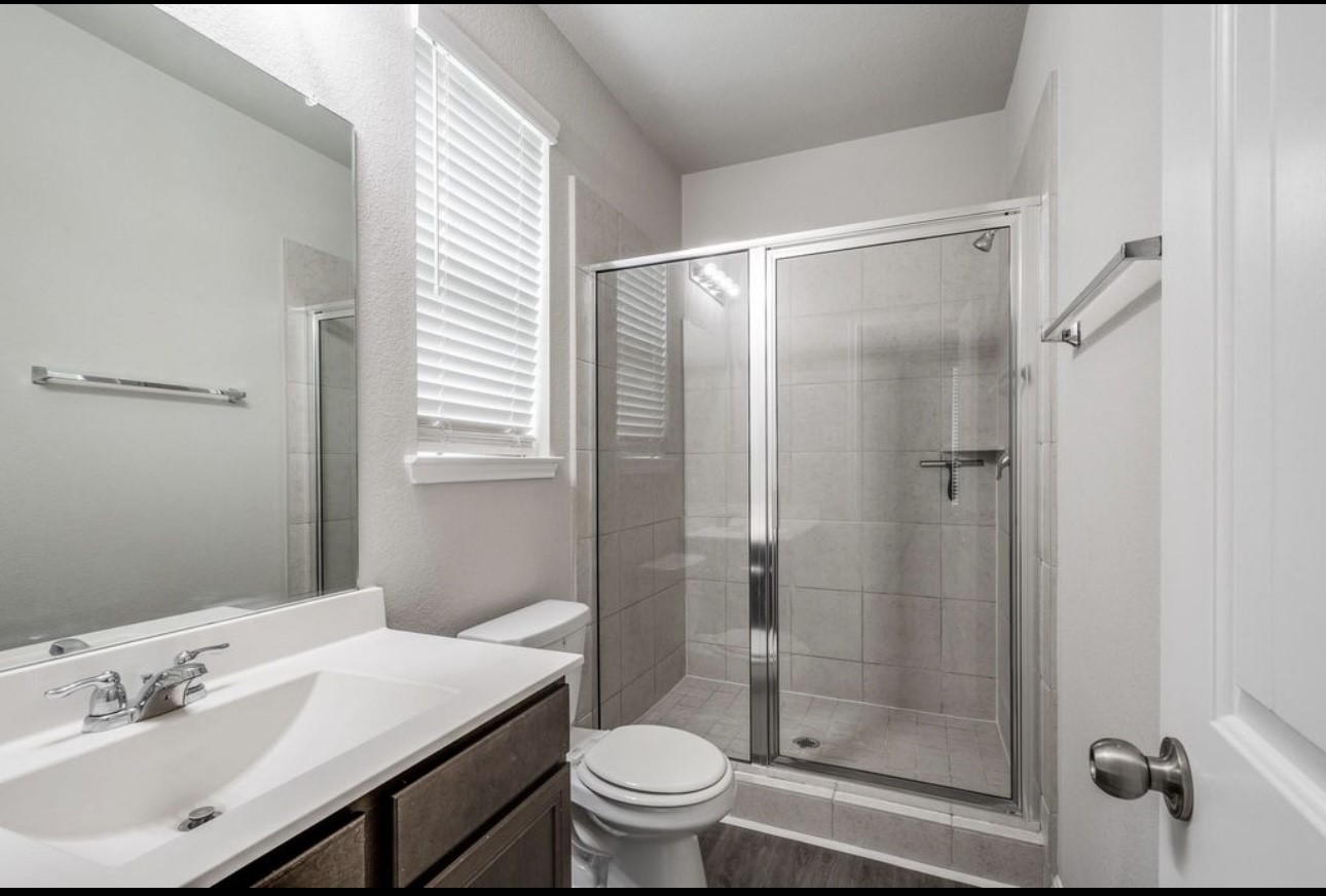 17542 Holroyd Road Humble, TX 77346 - Photo 9 of 16 a bathroom with a sink a toilet and shower
