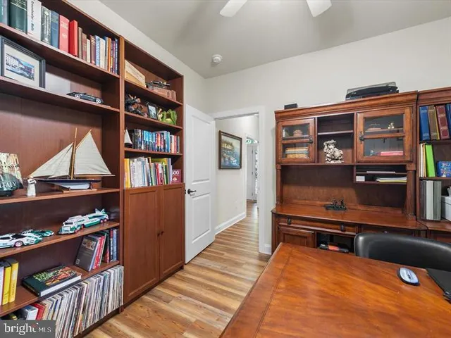 a view of living room filled with furniture and book shelf