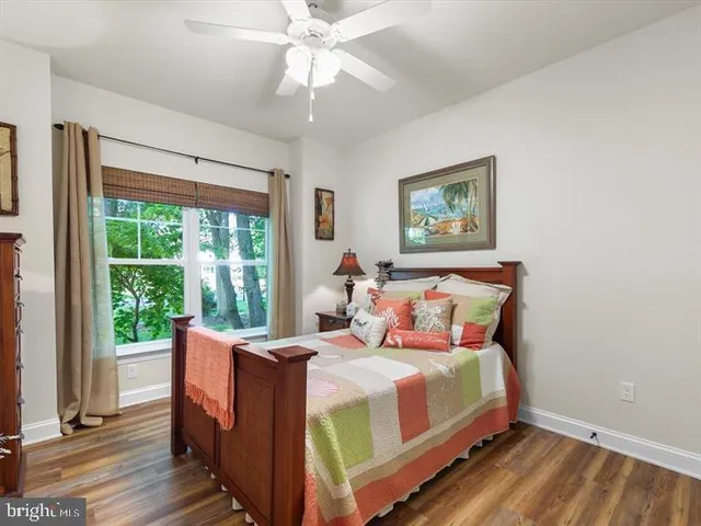 a bedroom with a large bed and a large window