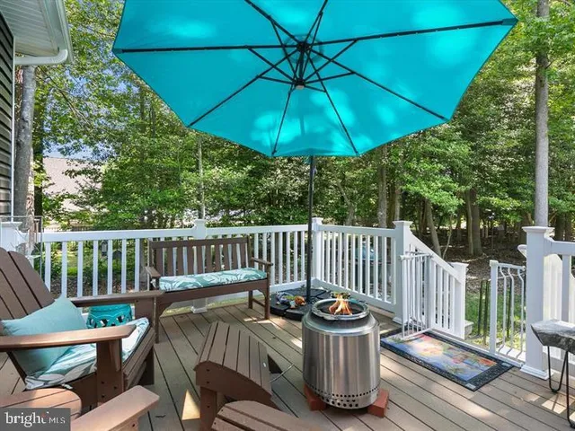 a view of a deck with furniture and wooden deck