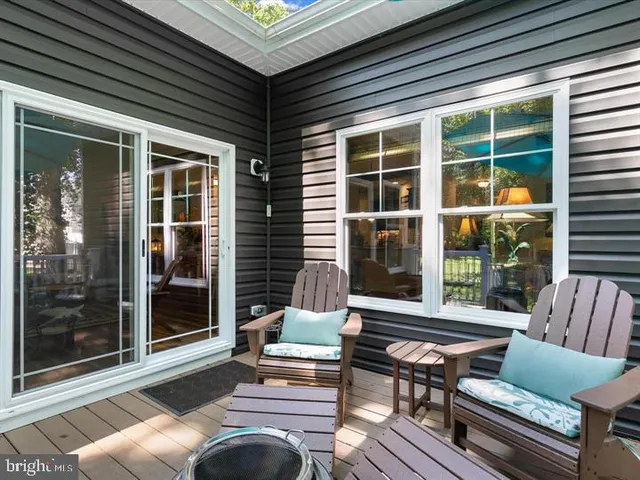 a balcony with furniture and a potted plant