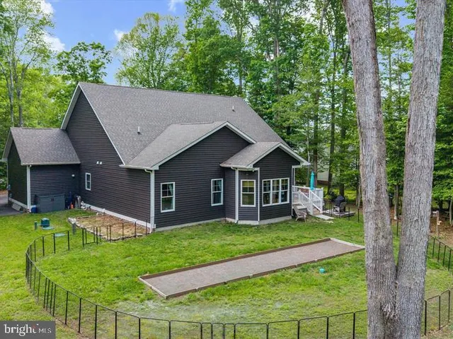 a view of a house with a yard and sitting area