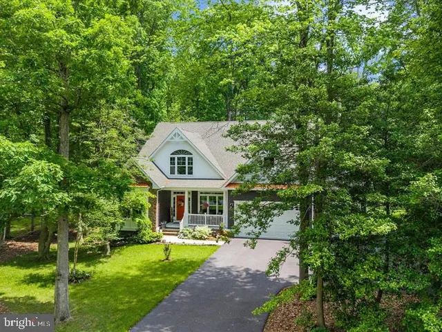 a front view of a house with swimming pool having outdoor seating