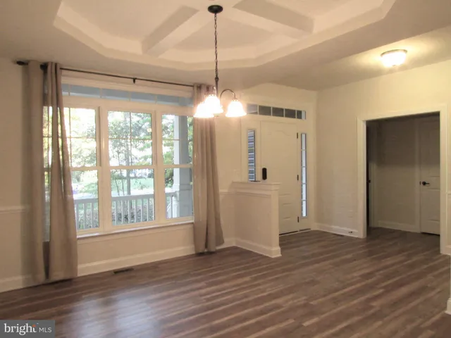a view of a room with wooden floor and windows